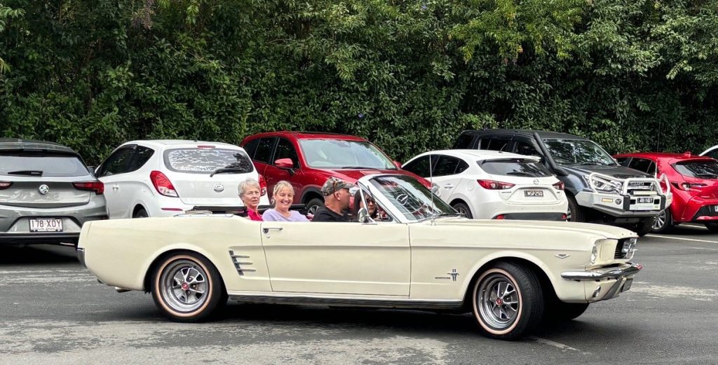 Arriving in style to high tea in old mustang